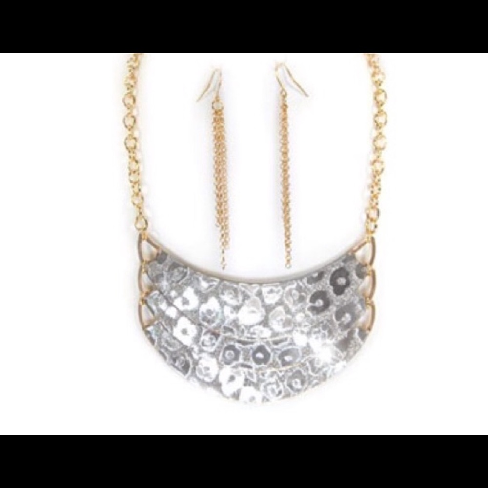 Glittery silvertone crescent shaped necklace.